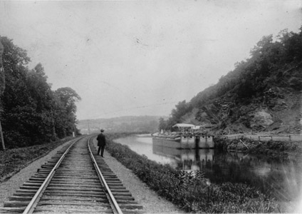 Two hinge (or section) boats wait to be loaded at the Goat Hill stone quarry south of Lambertville around the year 1900.  Several quarries along the Delaware River produced brownstone for buildings in Trenton, Philadelphia and New York City.  Streets in those cities were also paved with cobblestones taken from the bed of the Delaware River and transported through the Delaware and Raritan Canal through the Lambertville outlet lock.